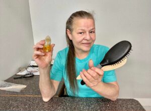 Betty Bizzarre holds hair extension brushes